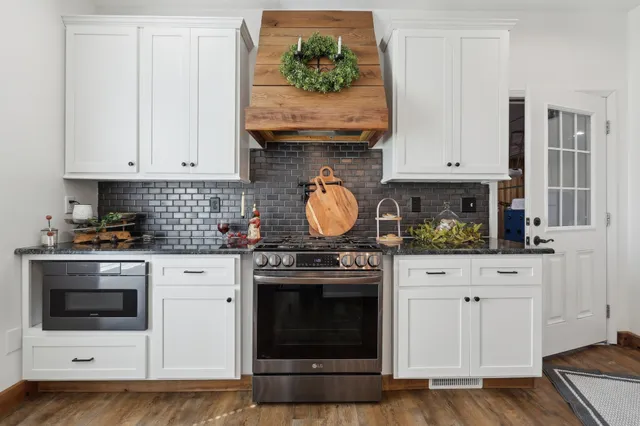 a kitchen with granite countertop a stove a washer and dryer