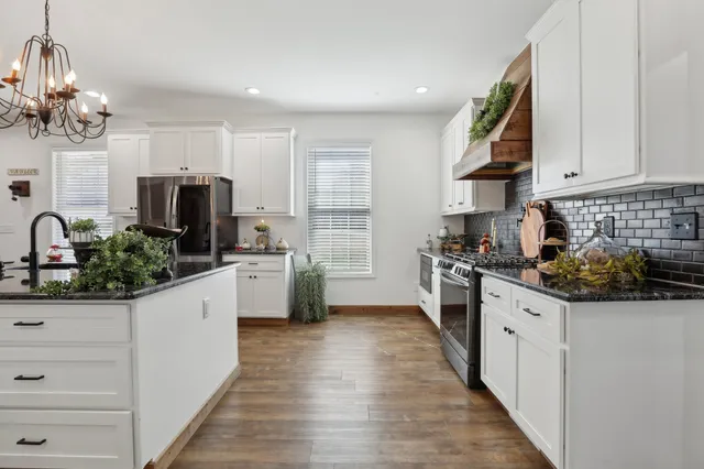 a kitchen with stainless steel appliances a sink stove and refrigerator