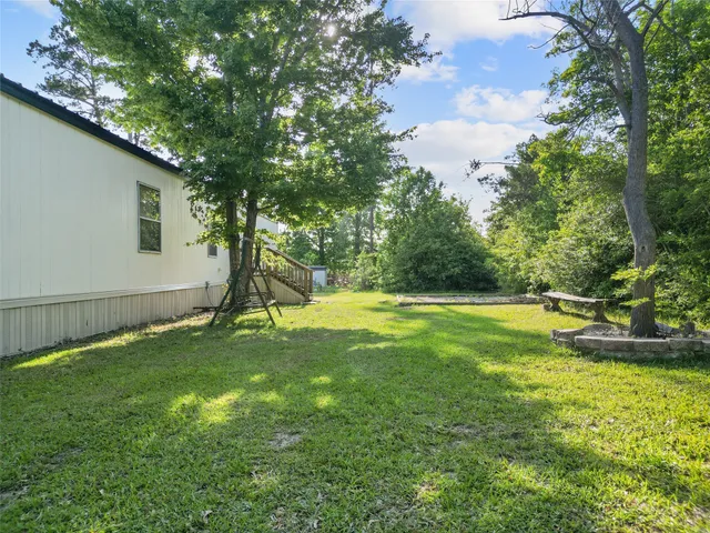 a view of a backyard with swimming pool