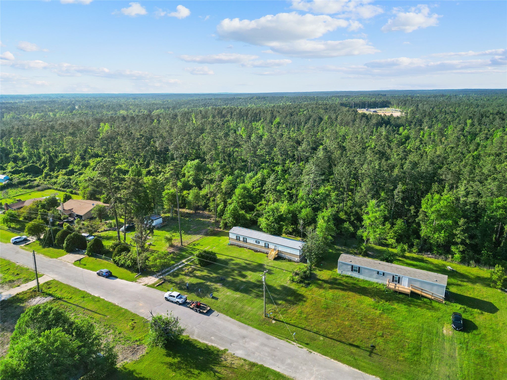443 West Lone Oak Road Onalaska, TX 77360 - Photo 18 of 21 a view of a city with lush green forest