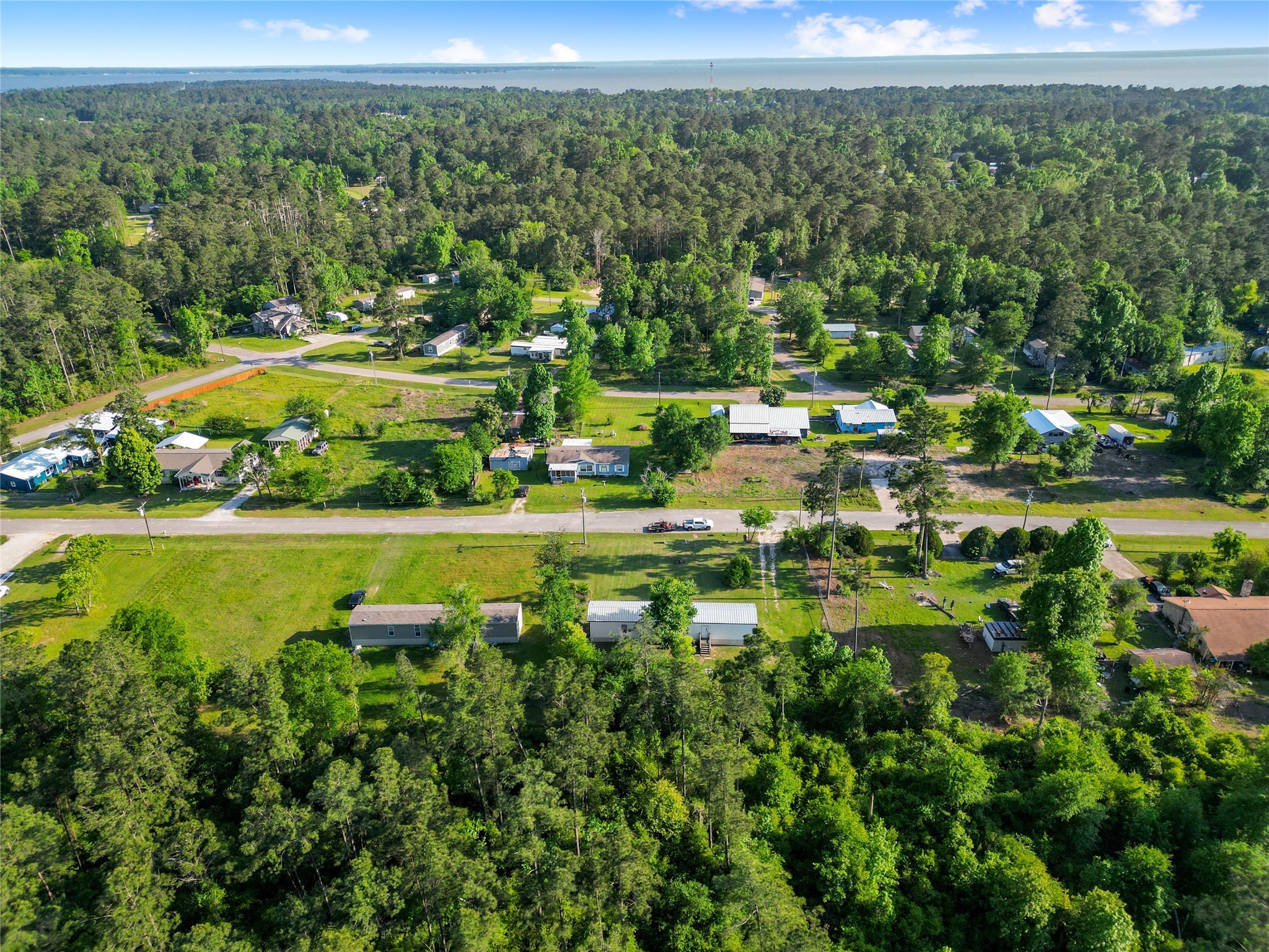 443 West Lone Oak Road Onalaska, TX 77360 - Photo 19 of 21 a view of a lake with a yard