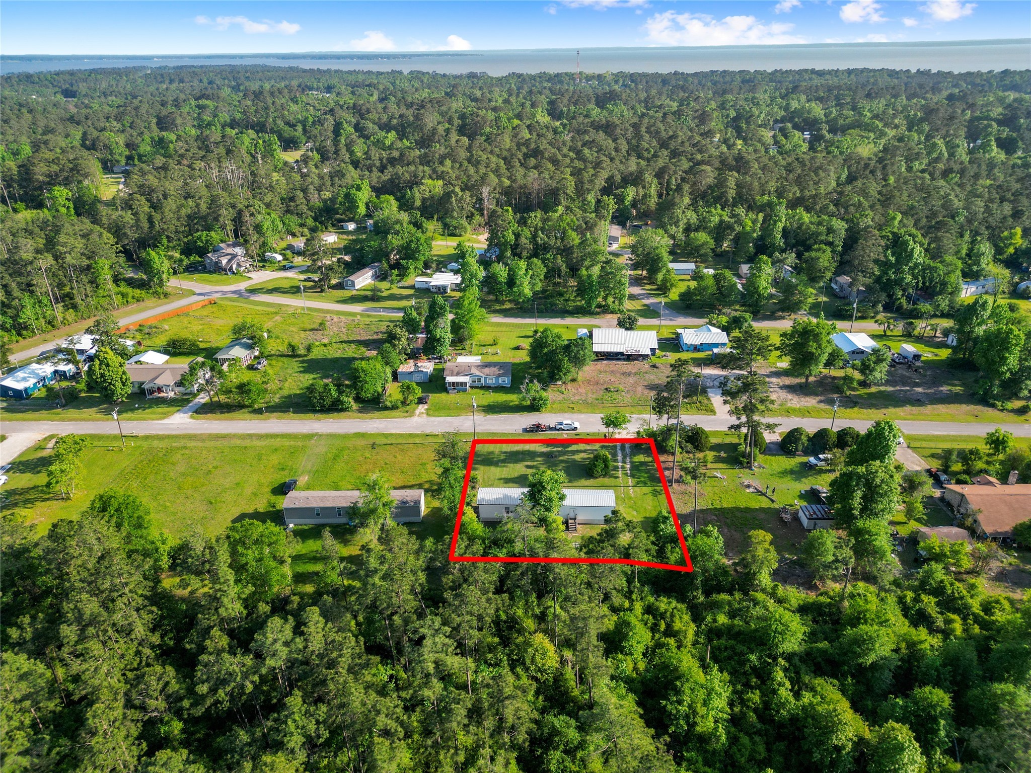 443 West Lone Oak Road Onalaska, TX 77360 - Photo 20 of 21 a view of a lake with a house