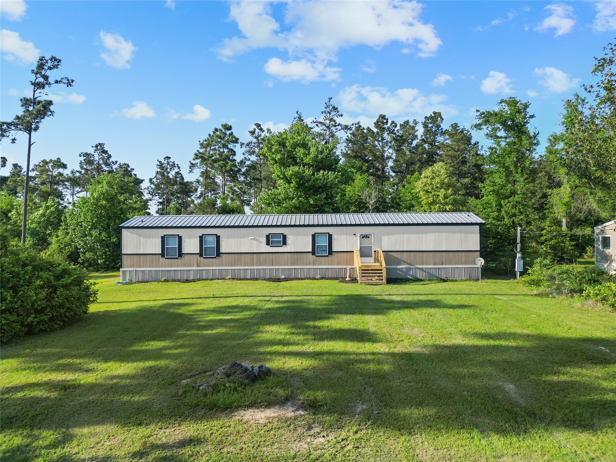 443 West Lone Oak Road Onalaska, TX 77360 - Photo 2 of 21 a front view of a house with a yard