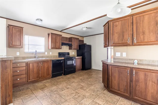 a kitchen with stainless steel appliances granite countertop a refrigerator and sink