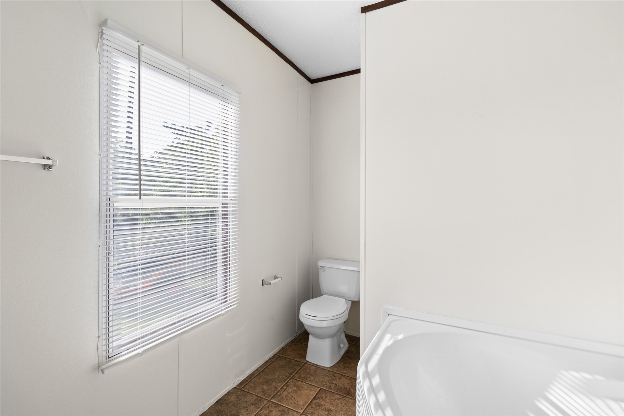 443 West Lone Oak Road Onalaska, TX 77360 - Photo 10 of 21 a bathroom with a granite countertop toilet a sink and a window