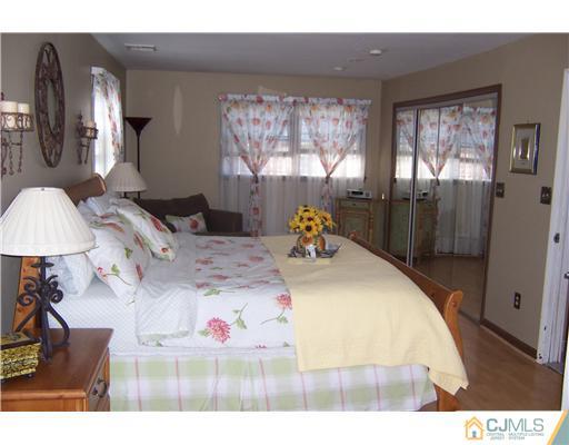 69 Morningside Road Colonia, NJ 07067 - Photo 13 of 25 a bed sitting in a bedroom next to a window