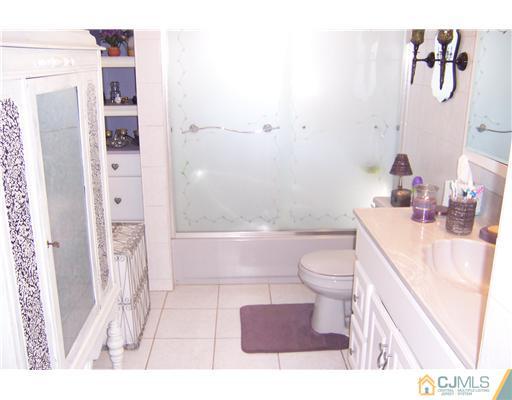 69 Morningside Road Colonia, NJ 07067 - Photo 14 of 25 a bathroom with a sink a toilet and shower