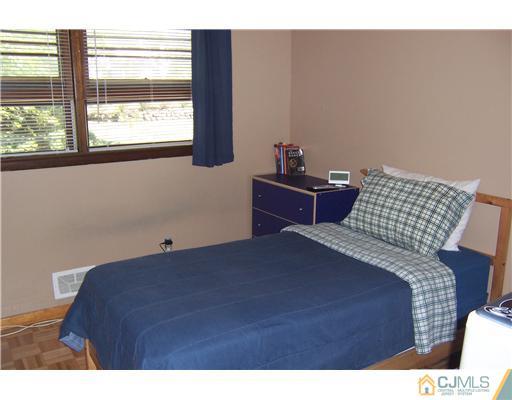 69 Morningside Road Colonia, NJ 07067 - Photo 15 of 25 a bedroom with a bed and a window