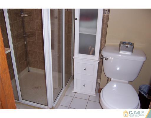 69 Morningside Road Colonia, NJ 07067 - Photo 16 of 25 a bathroom with a toilet and a shower