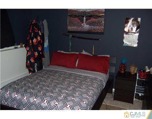 69 Morningside Road Colonia, NJ 07067 - Photo 17 of 25 a bed sitting in a bedroom and painting on the wall
