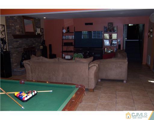 69 Morningside Road Colonia, NJ 07067 - Photo 19 of 25 a living room with furniture and a flat screen tv