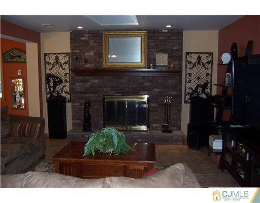 69 Morningside Road Colonia, NJ 07067 - Photo 21 of 25 a living room with furniture and a fireplace