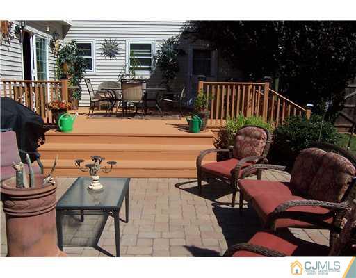 69 Morningside Road Colonia, NJ 07067 - Photo 22 of 25 a view of a chairs and tables in the back yard of the house