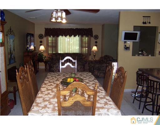 69 Morningside Road Colonia, NJ 07067 - Photo 6 of 25 a living room with furniture a fireplace and a chandelier