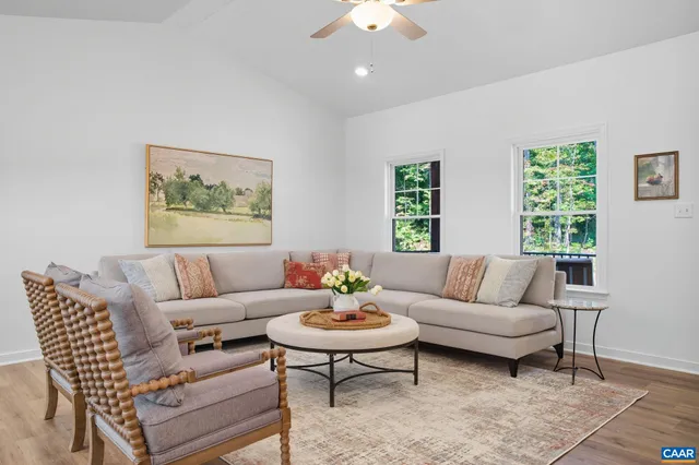 a living room with furniture and wooden floor