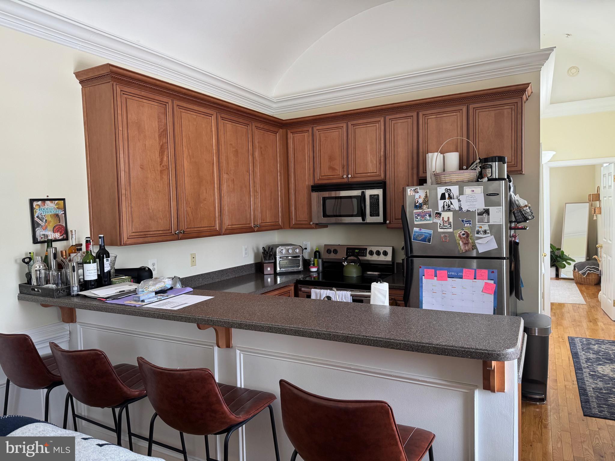 1 Kings Court, Unit 5 Haddonfield, NJ 08033 - Photo 4 of 15 a kitchen with stainless steel appliances granite countertop a stove top oven a sink dishwasher and cabinets with wooden floor