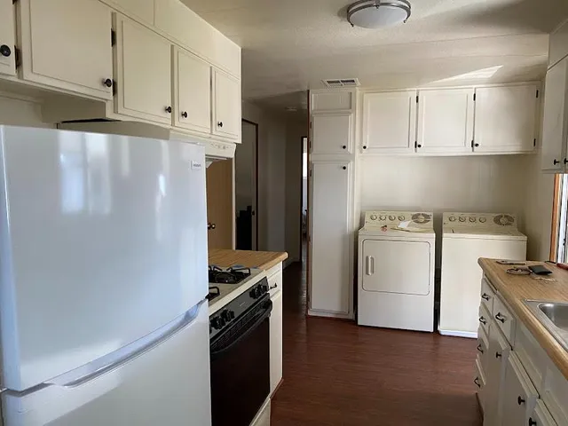 a kitchen with a white cabinets and white appliances