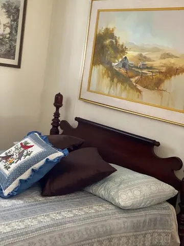 a bed sitting in a bedroom next to a window