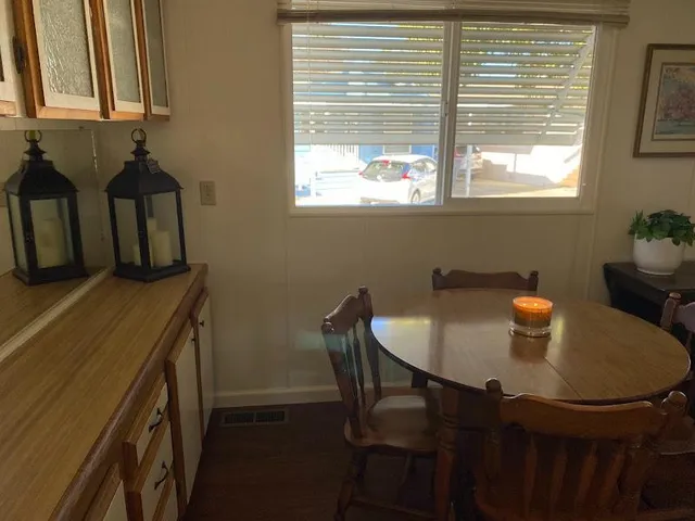 a dining room with furniture and window