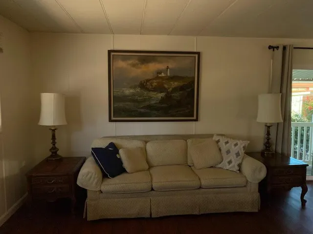 a living room with furniture and a painting on the wall