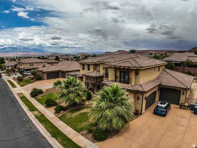 3683 South 2640 West St. George, UT 84790 - Photo 5 of 41 Mediterranean-inspired residence featuring a stucco exterior, tile roofing, and multiple garage doors