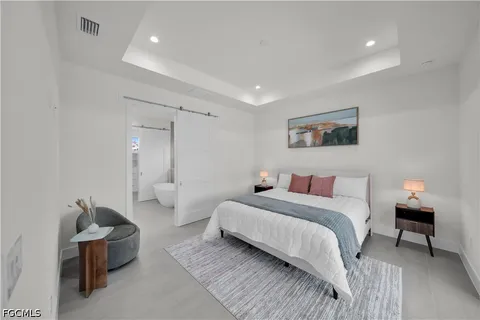 a bedroom with a large bed and a large window