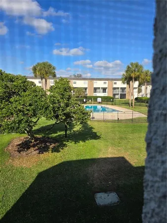 a view of a big yard with table and chairs