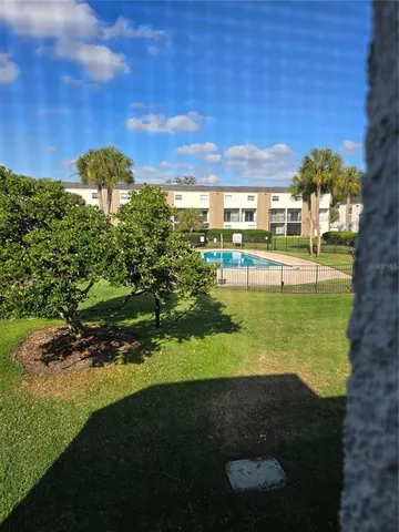 a view of a big yard with table and chairs