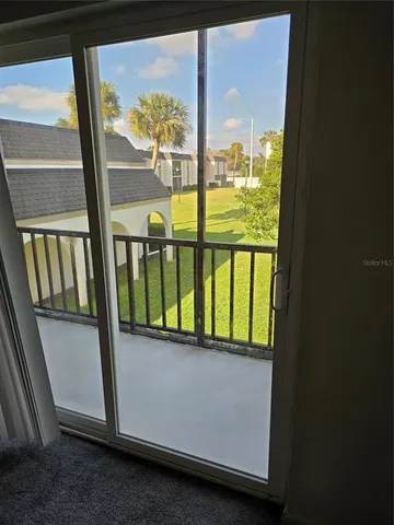 a view of a glass door with a balcony