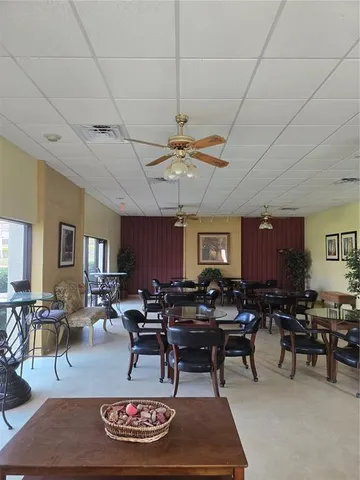 a living room with furniture a rug and a window