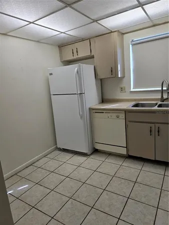 a utility room with cabinets washer and dryer