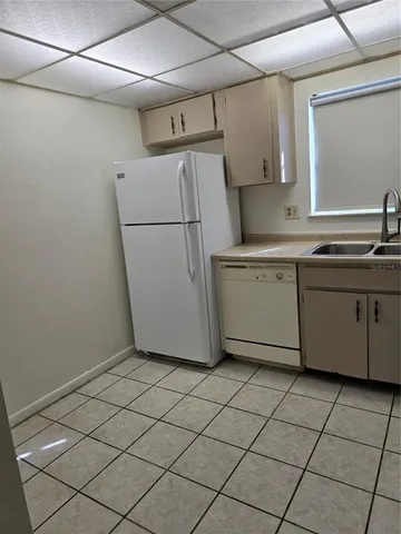 a utility room with cabinets washer and dryer