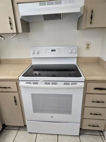 a stove top oven sitting inside of a kitchen
