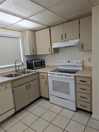 a kitchen with cabinets stainless steel appliances and a sink