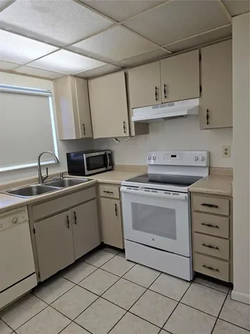 a kitchen with cabinets stainless steel appliances and a sink