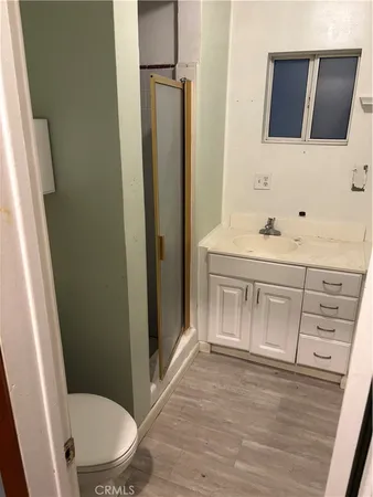 a bathroom with a sink a toilet a mirror and vanity