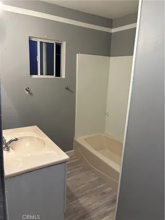 a bathroom with a tub and sink