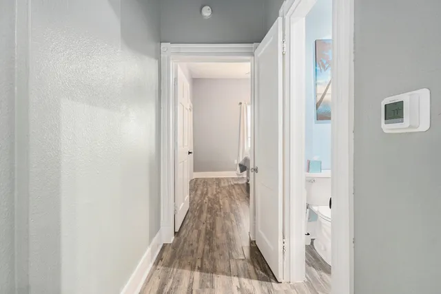 a view of a room with wooden floor