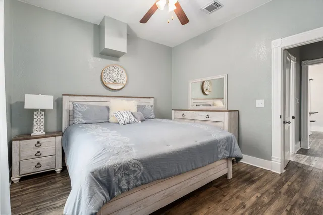 a bedroom with a bed and a chandelier