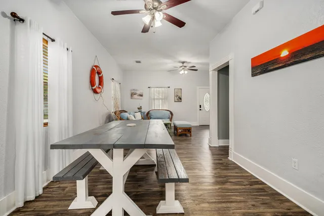 a view of a dining room with furniture and wooden floor