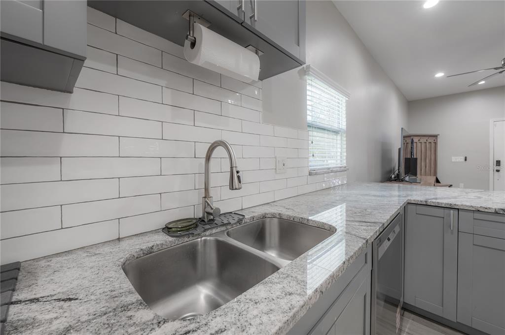 2341 West Chestnut Street Tampa, FL 33607 - Photo 9 of 42 a kitchen with a sink cabinets and window