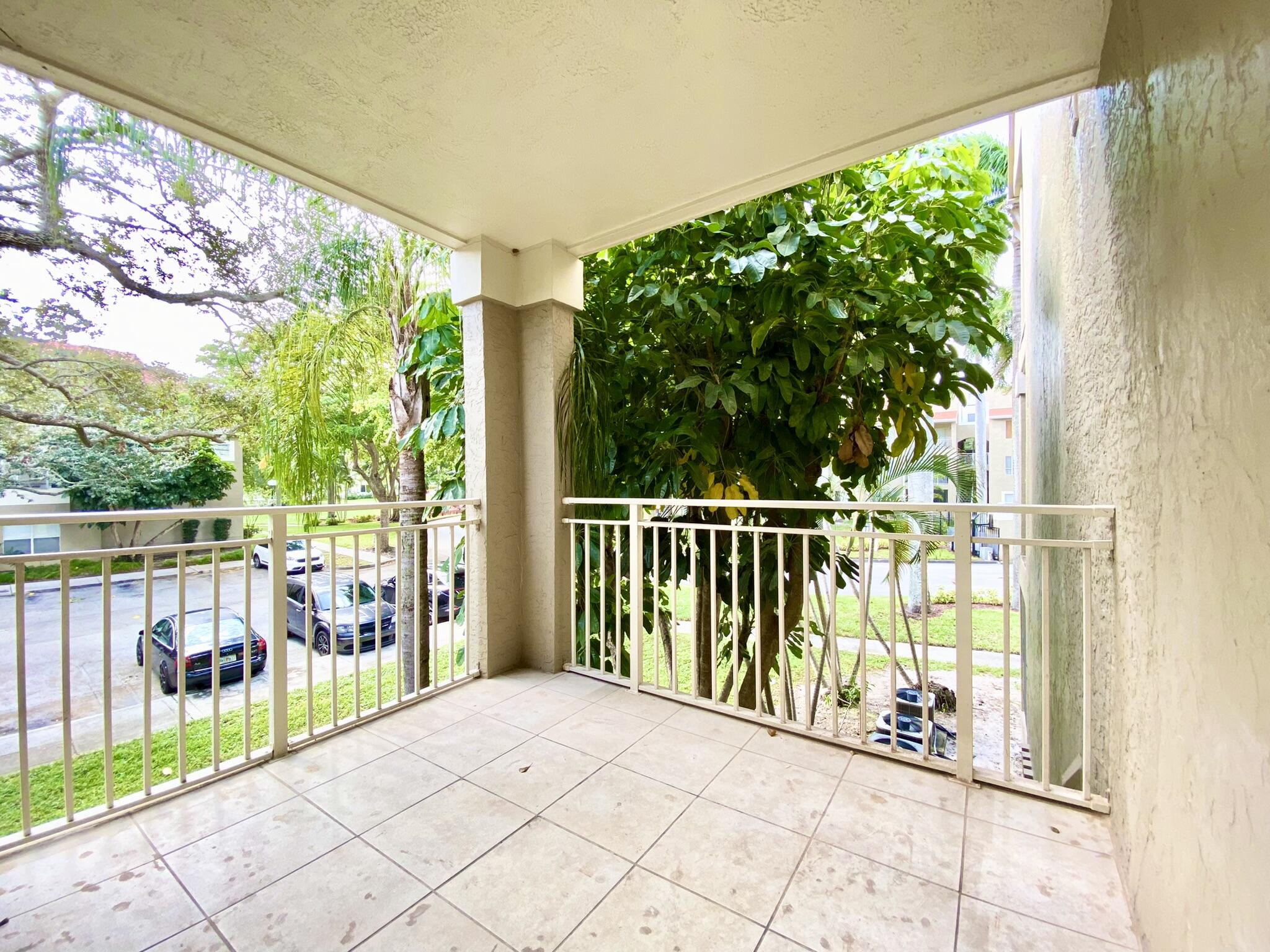 1705 Palm Cove Boulevard, Unit 201 Delray Beach, FL 33445 - Photo 11 of 21 a balcony with trees in front of it