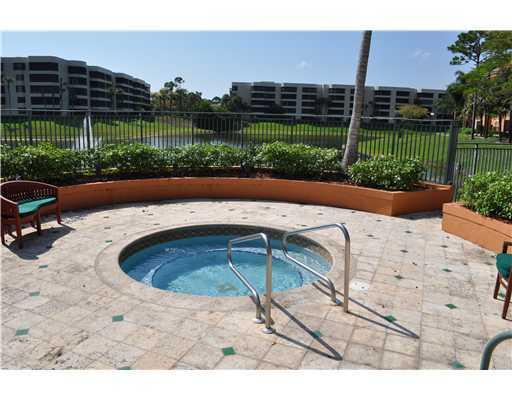 1705 Palm Cove Boulevard, Unit 201 Delray Beach, FL 33445 - Photo 18 of 21 a swimming pool with outdoor seating and yard