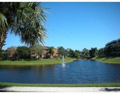 1705 Palm Cove Boulevard, Unit 201 Delray Beach, FL 33445 - Photo 19 of 21 a view of a lake from a yard