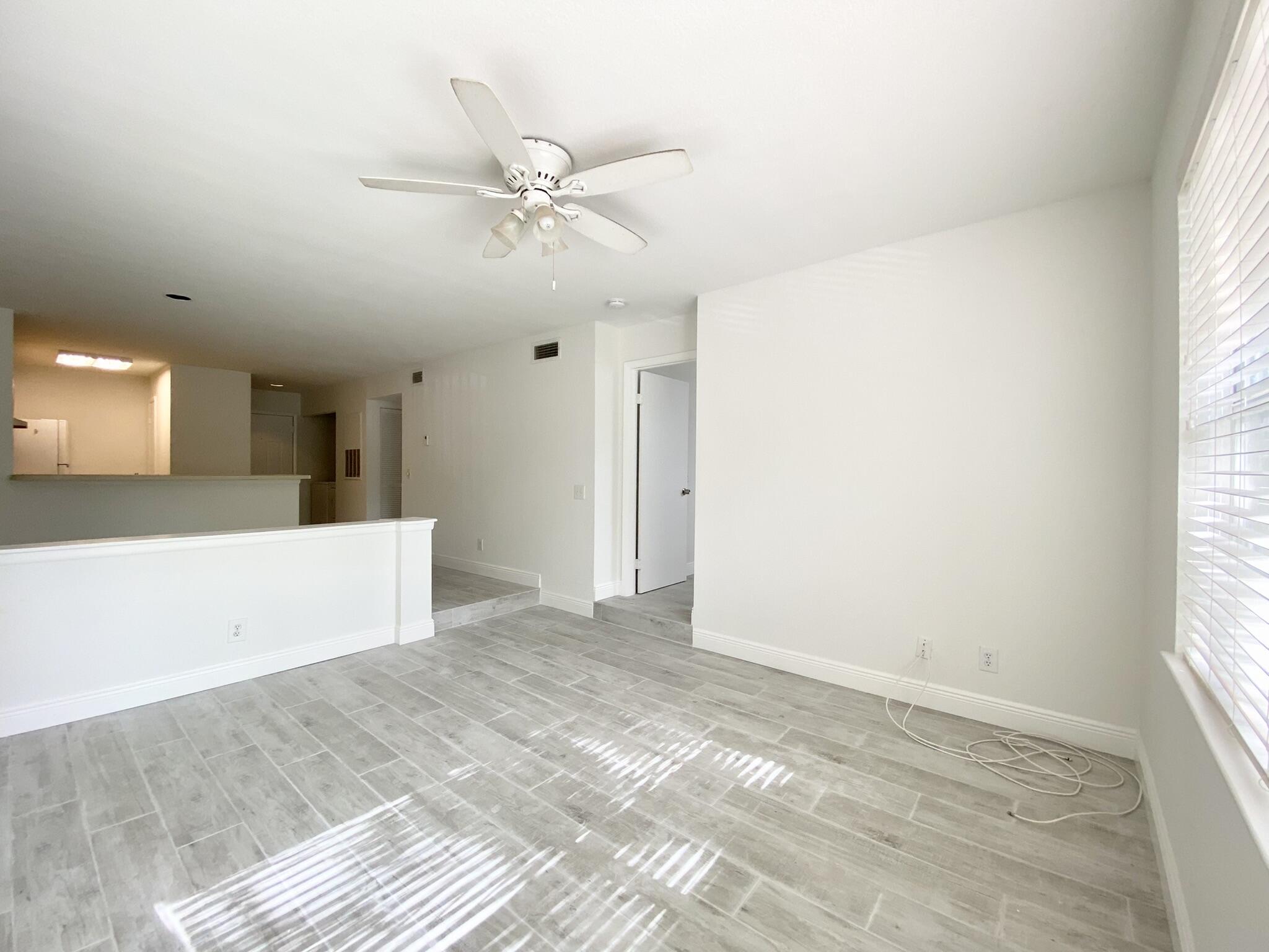 1705 Palm Cove Boulevard, Unit 201 Delray Beach, FL 33445 - Photo 8 of 21 a view of an empty room with a window