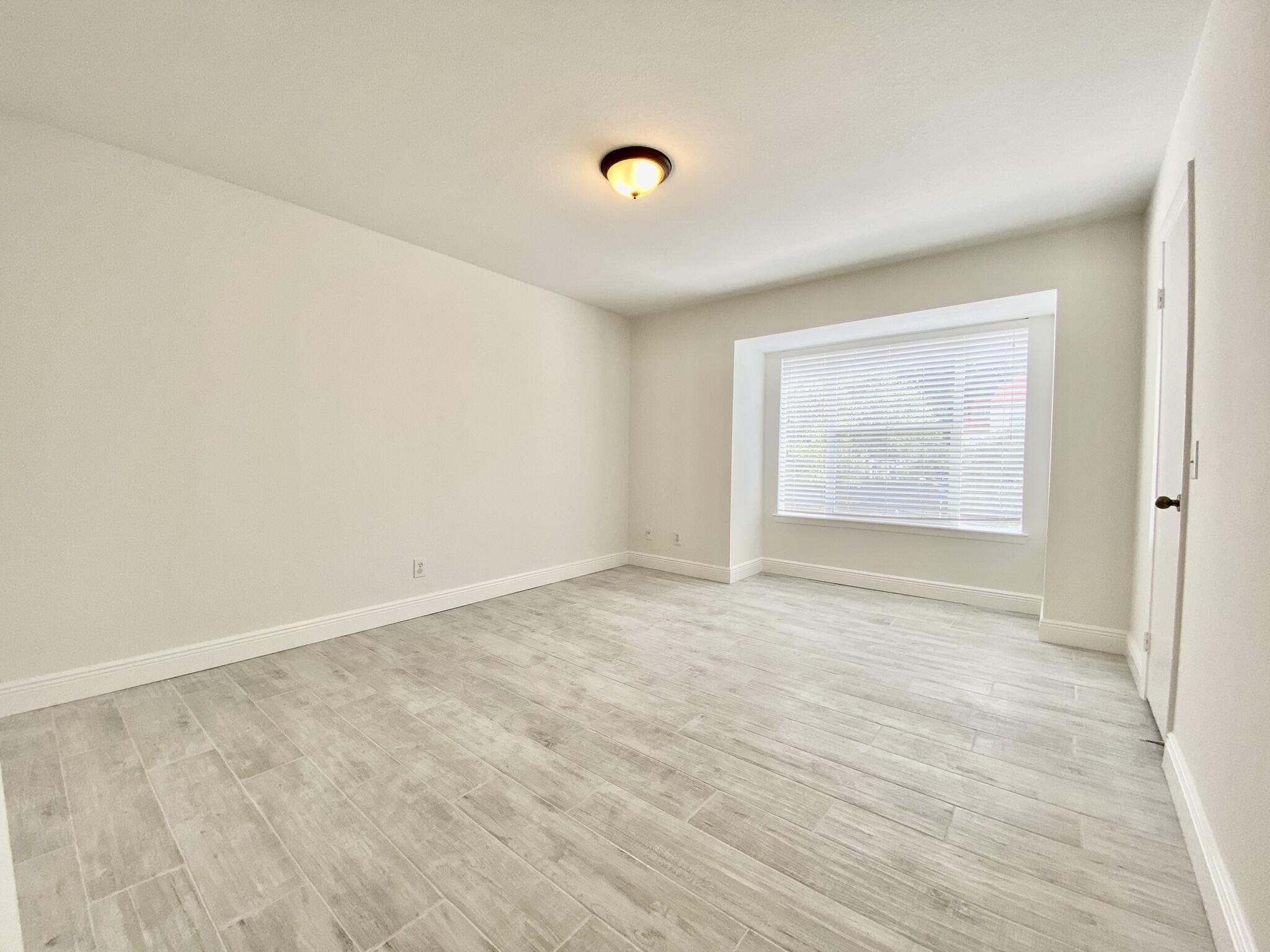 1705 Palm Cove Boulevard, Unit 201 Delray Beach, FL 33445 - Photo 10 of 21 an empty room with windows