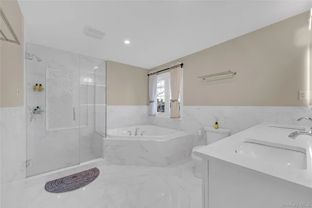 a bathroom with a tub sink and mirror
