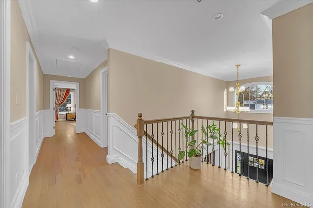 a view of a hallway with windows and stairs