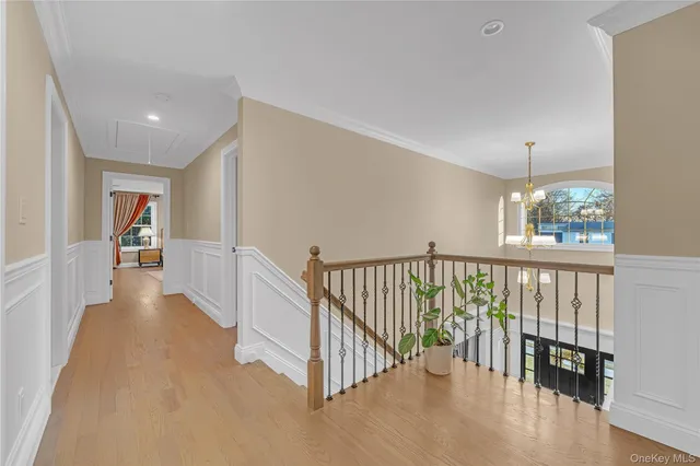 a view of a hallway with windows and stairs