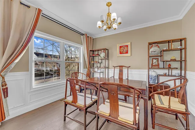 a view of a dining room with furniture and chandelier